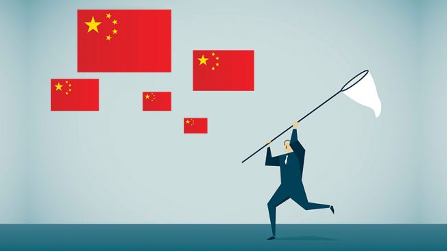 On the left there are five Chinese flags; on the right there is a man with a net and it appears that he is trying to catch the flags