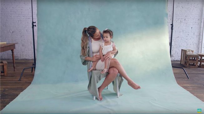 Chrissy Teigen communicates with her daughter as she is on the set for a Pampers advertisement