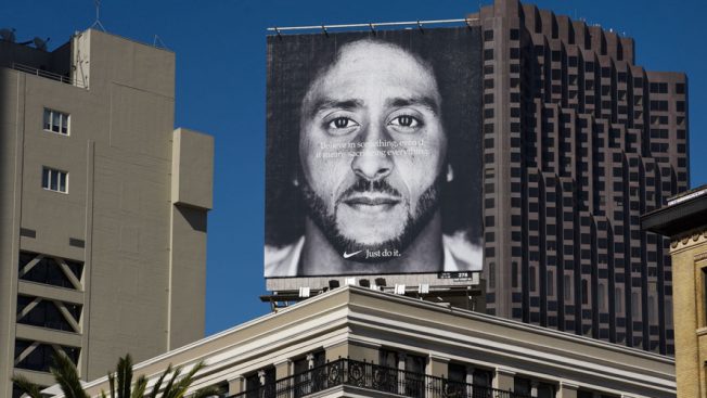 Nike's Colin Kaepernick ad is displayed on a billboard above a building.