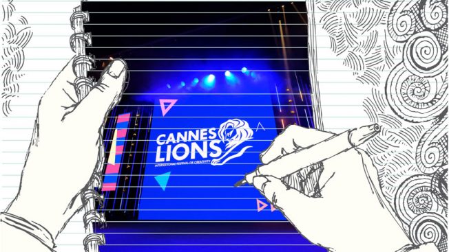 On the front of a notebook hands are seen doodling 'Cannes Lions;' in the background are various squiggly lines