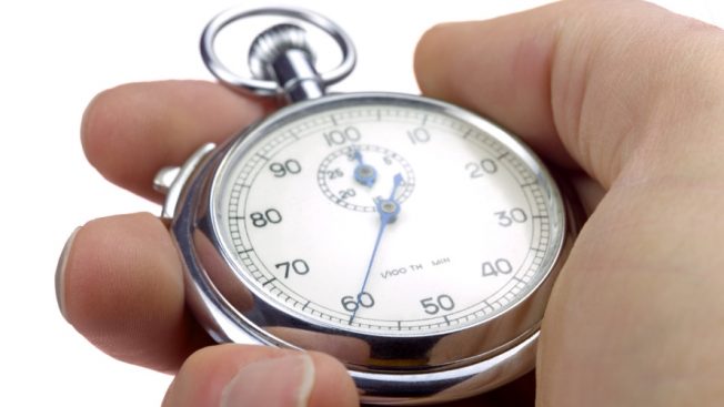 Hand holding a stopwatch currently at 60 seconds