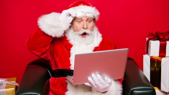 Santa Claus looking at his laptop shocked
