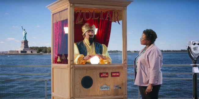 A woman visits a fortune-telling booth near the Statue of Liberty.