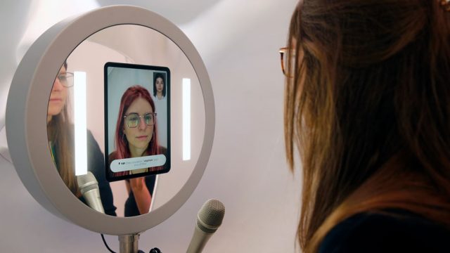 A woman using L'Oréal's virtual hair try-on experience