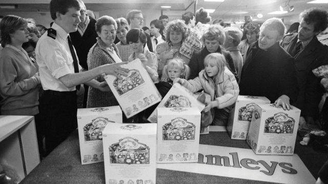 People grab packages of Cabbage Patch Kids.