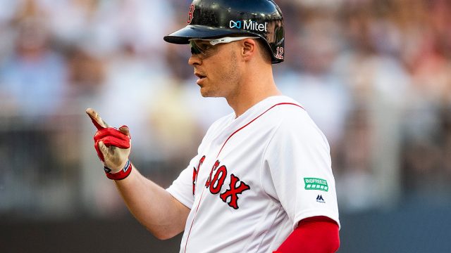 MLB Boston Red Sox player Brock Holt in profile showing branded biofreeze logo on his sleeve and mitel logo on helmet during Major League Baseball London Series against the New York Yankees at West Ham London Stadium