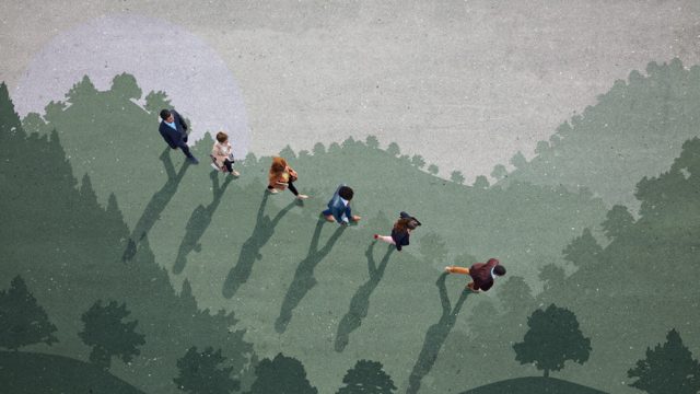 Overhead view of people walking over shadows of trees and hills