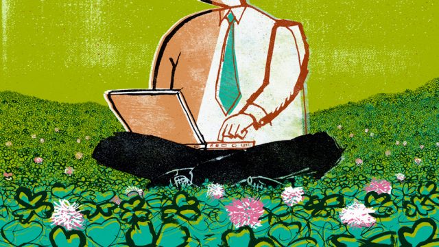 Businessman with laptop sitting on a field of grass and flowers