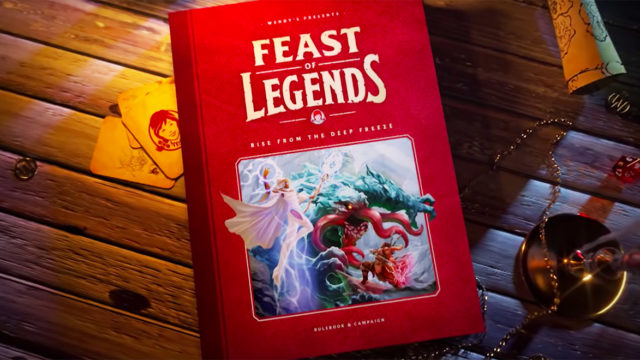 A role playing game book for Feast of Legends sits on a wooden table