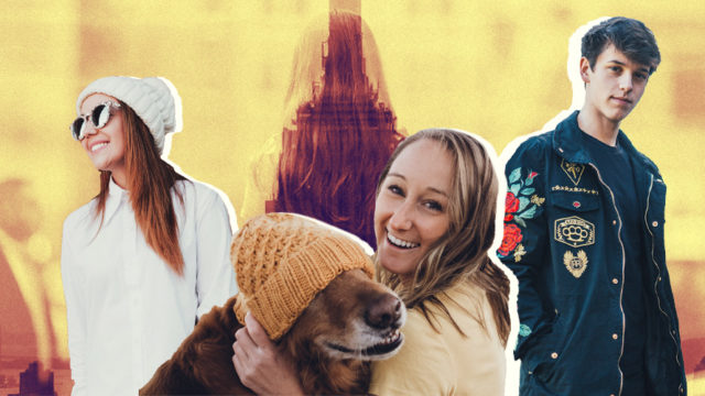 A photo of three people with a woman holding a dog with a yellow hat on in the front