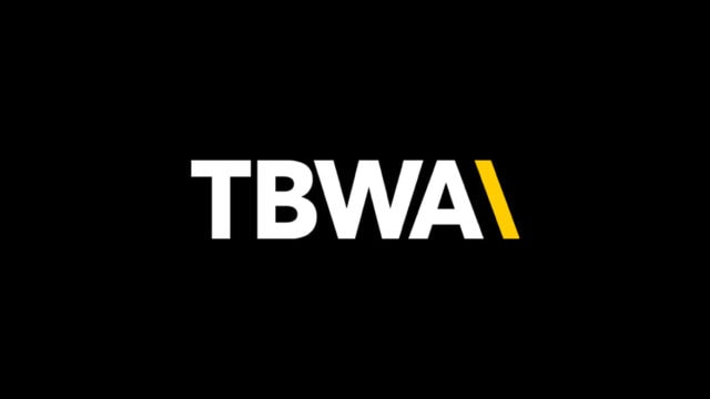 Black background with tbwa logo in white and yellow lettering.
