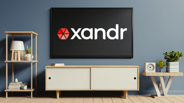 a living room with a large tv with the xandr logo