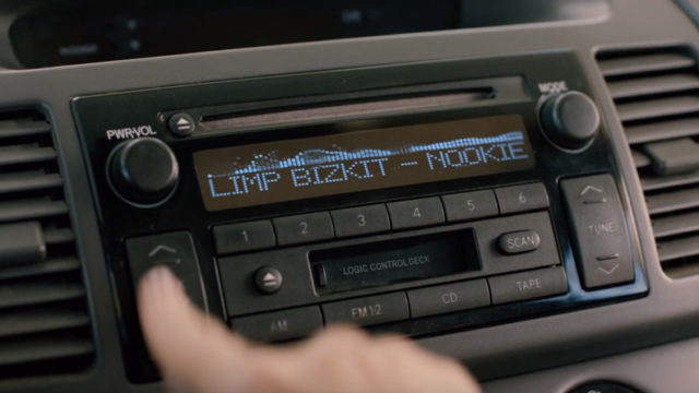 Stuck car cd player playing Limp Bizkit's Nookie with blurred hands trying to change the music
