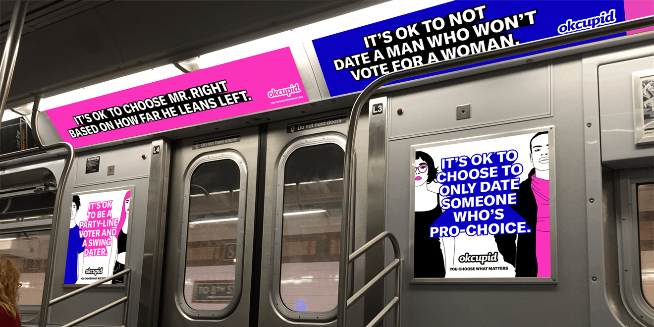 A subway car with OkCupid ads