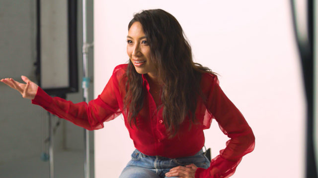 TV host Jeannie Mai gestures in frustration to a camera during an interview