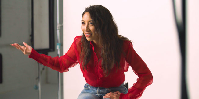 TV host Jeannie Mai gestures in frustration to a camera during an interview