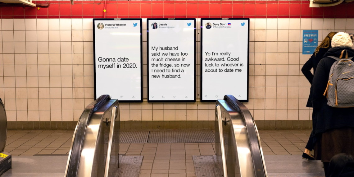 An escalator in front of a screen with tweets displayed on them