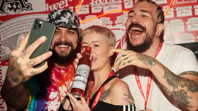 Influencers posed in front of branded wallpaper backdrops at the BudX Hotel.