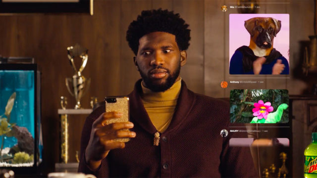 A still of Joel Embiid on his phone looking at GIFs