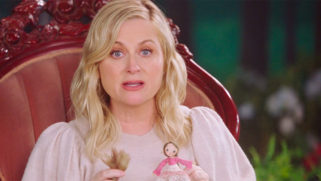 Amy Poehler holds a Rapunzel doll while narrating a fairy tale