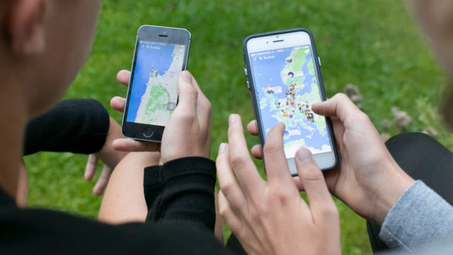 People looking at maps on their smartphones