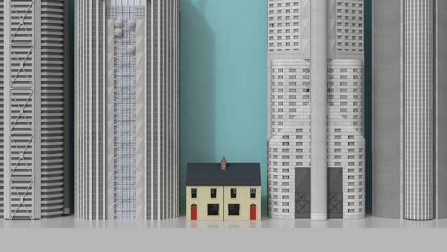 a small house sandwiched between skyscrapers