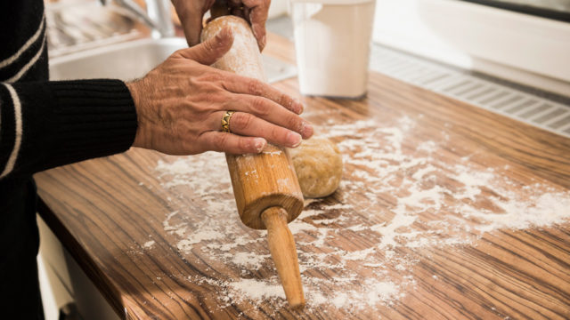 a baker flouring a rolling pin