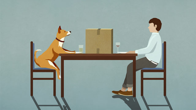 a man and his dog sitting at a table