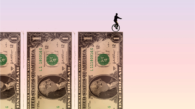 Three $1 bills and the shadow of a person on a unicycle on top of one bill