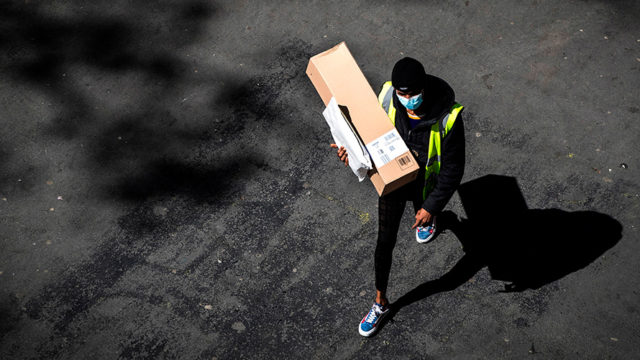 a delivery person carrying a package