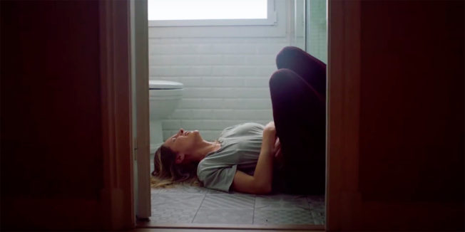 Woman in pain on the bathroom floor