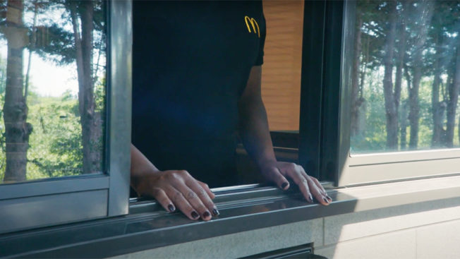 Image of a McDonald's drive-thru worker at a window