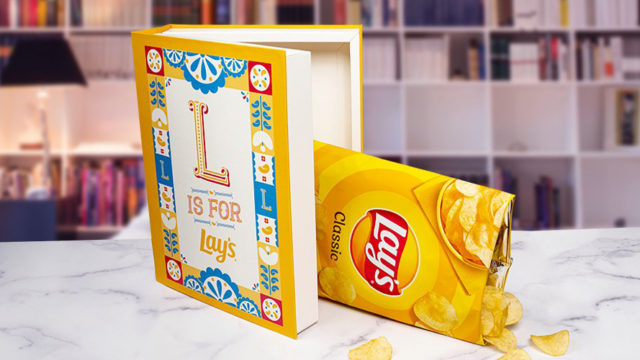 a lay's chip bag falling out of an open hollowed out book