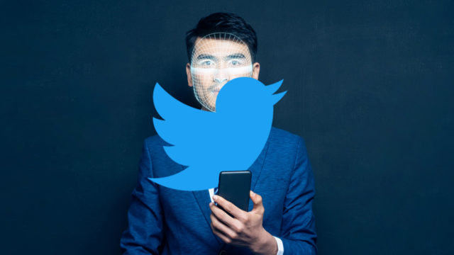 Twitter logo over image of person looking at a smartphone