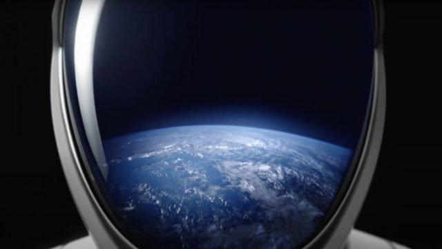 view of earth reflected in an astronaut's helmet