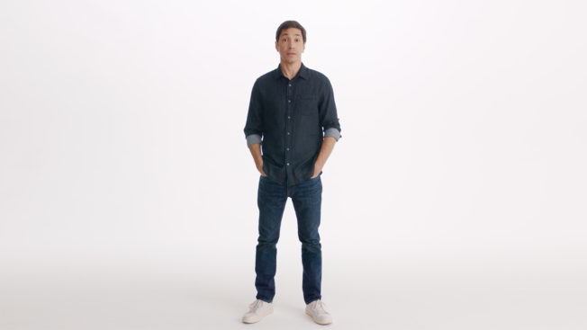 Actor Justin Long stands in front of a white background
