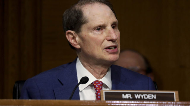 senator ron wyden speaking into a small microphone