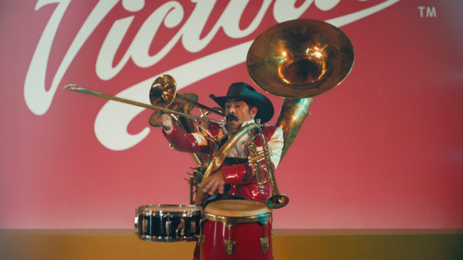 A one-man band in front of the Victoria logo