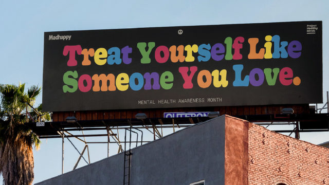A billboard that says, 'Treat yourself like someone you love'