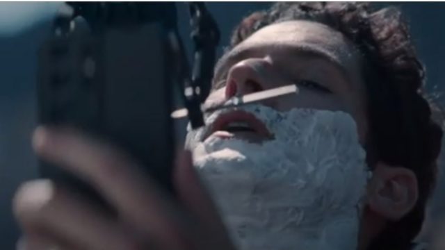 Actor Tom Ellis is shaved by a robot