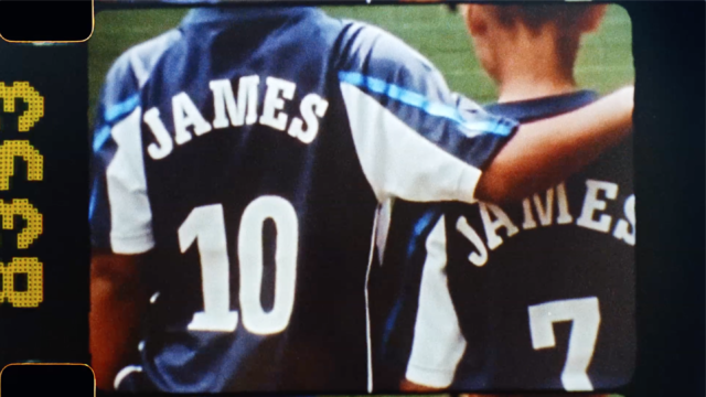 A behind shot of two young soccer players standing next to each other
