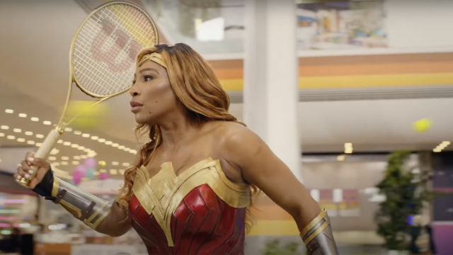 Serena Williams holds a tennis racquet while dressed as Wonder Woman