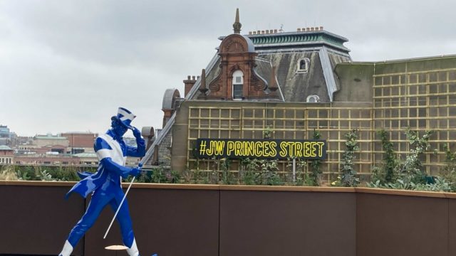 A Saltire emblazoned Striding Man on the rooftop at the Johnnie Walker Princes Street Experience.