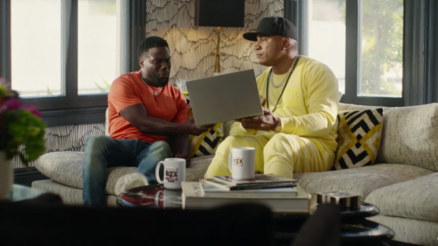 Kevin Hart and LL Cool Ja on a couch looking at a laptop