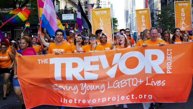 Pride Parade marchers with Trevor Project banner