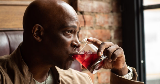 a man drinking a cocktail