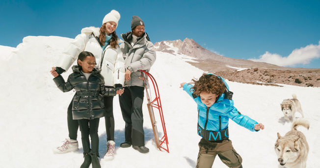 a family in snow gear on a mountain