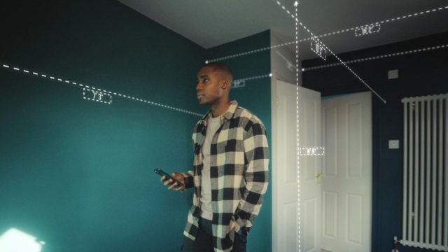 a man measuring his room with a laser