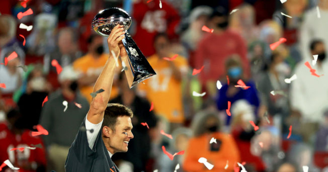 Quarterback Tom Brady holds the Lombardi Trophy after winning the Super Bowl