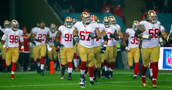 The San Francisco 49ers run out of a tunnel during a game at Wembley Stadium in London.